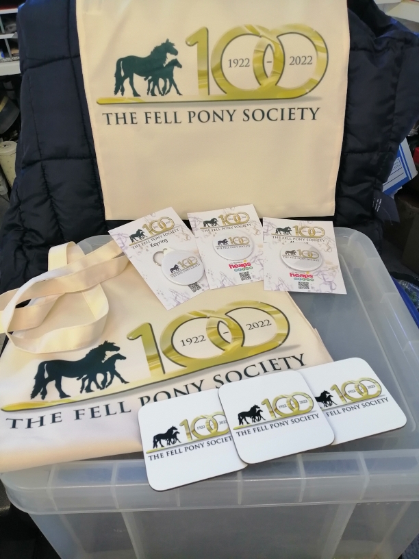 White Coasters and cream coloured bags with FPS Centenary Logo