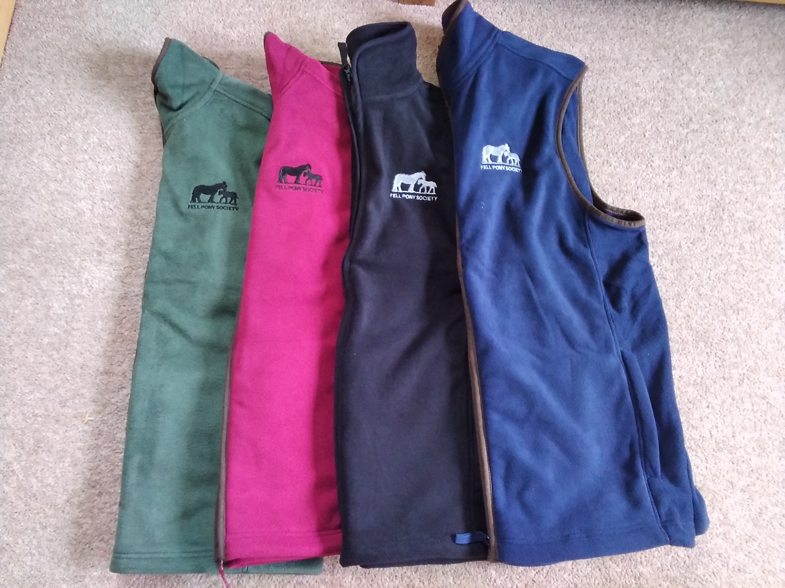 green, pink, black and dark blue gilets