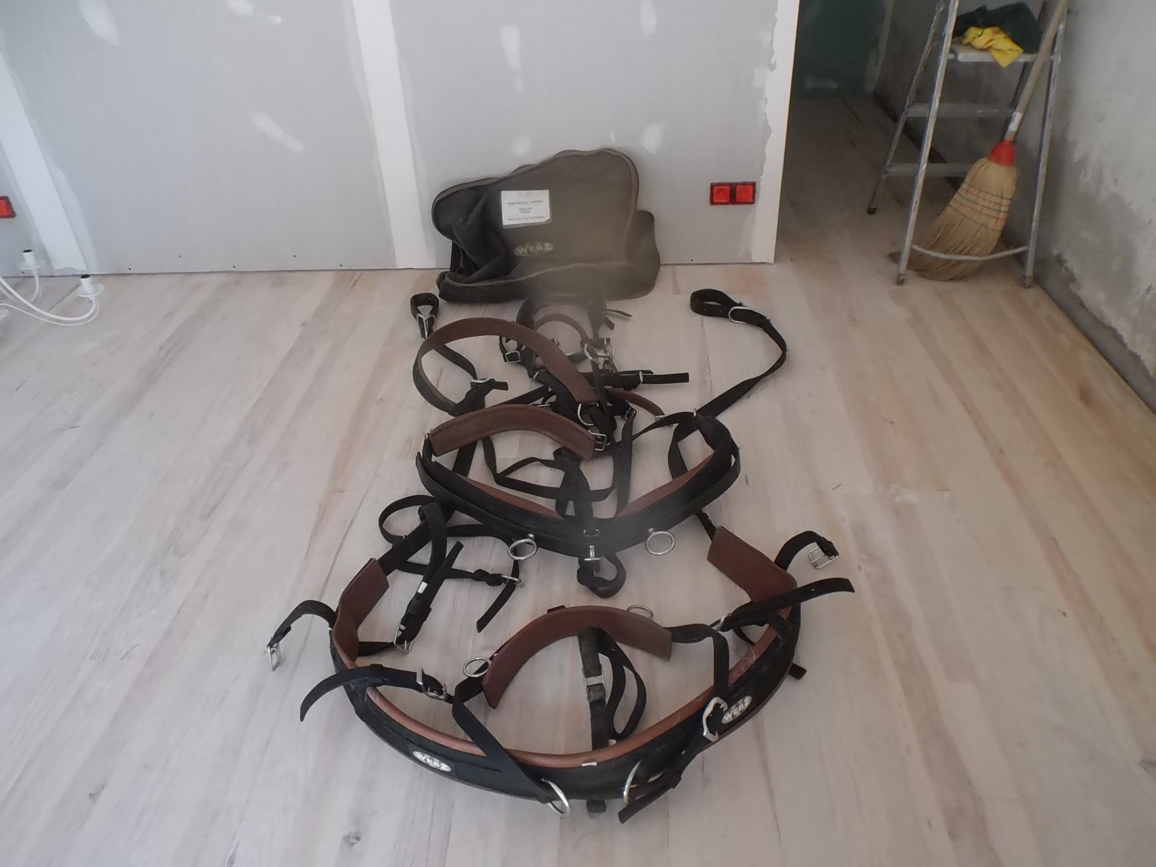 set of black straps laid out on the floor