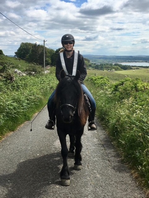 black pony with a rider facing camera